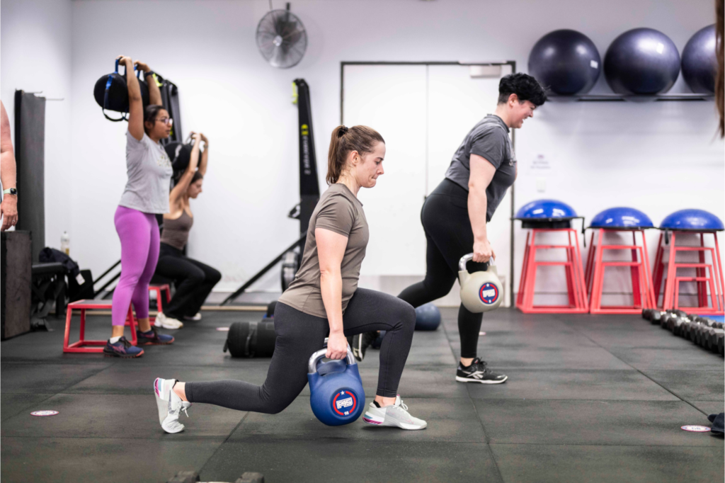 Participants at F45 Downtown Los Angeles engaging in functional fitness workouts, focusing on strength and mobility exercises.