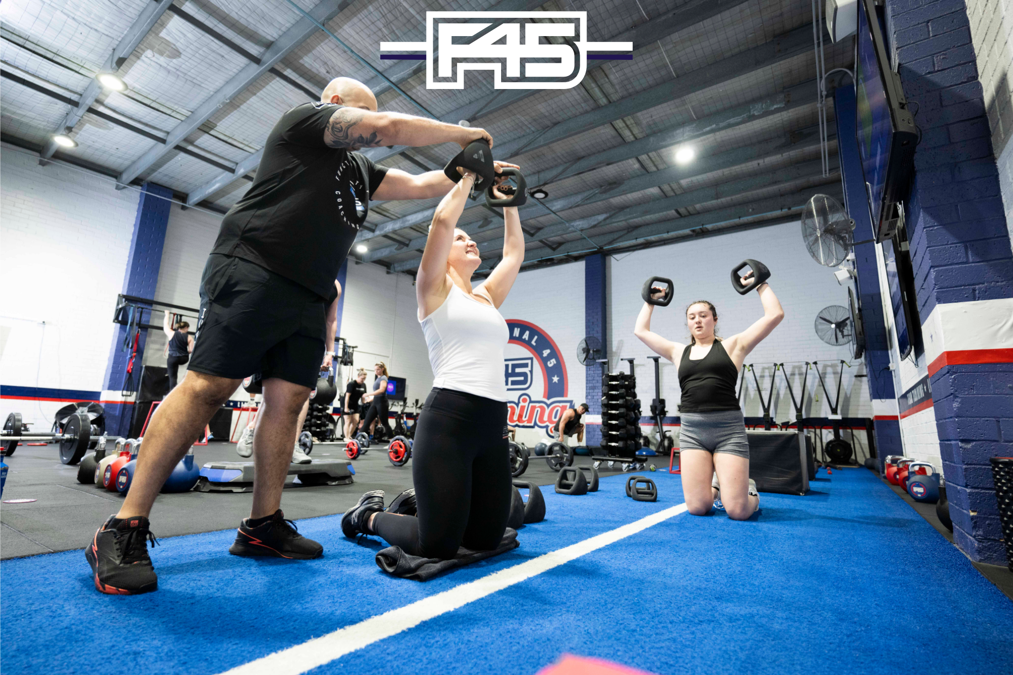 Participants engaging in a high-energy HIIT workout session at F45 Downtown Los Angeles studio.