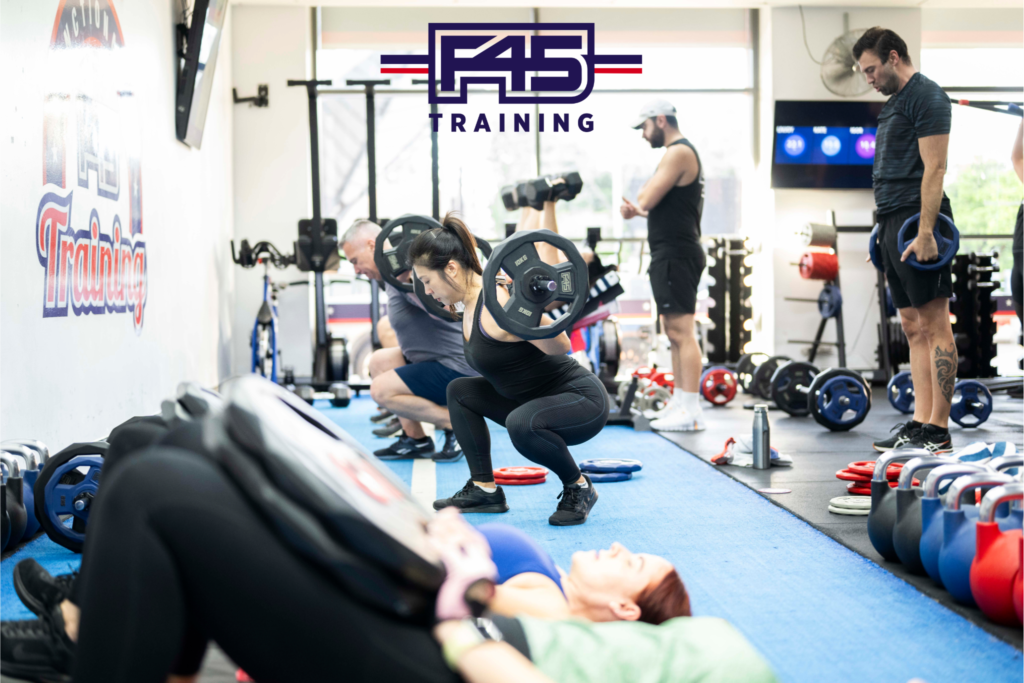 Participants engaging in intense HIIT workouts near me with a trainer guiding the session.