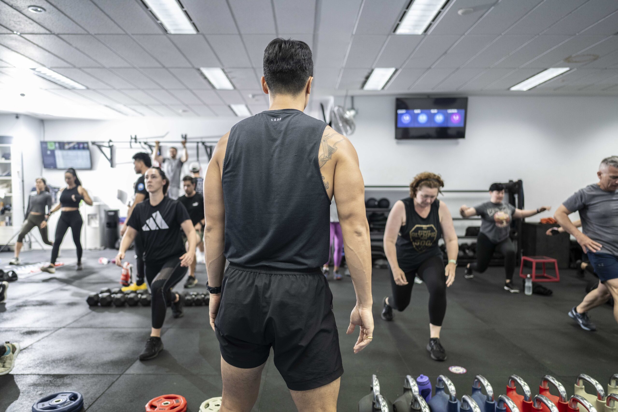 Participants in an F45 Los Angeles functional training session performing high-intensity workouts.