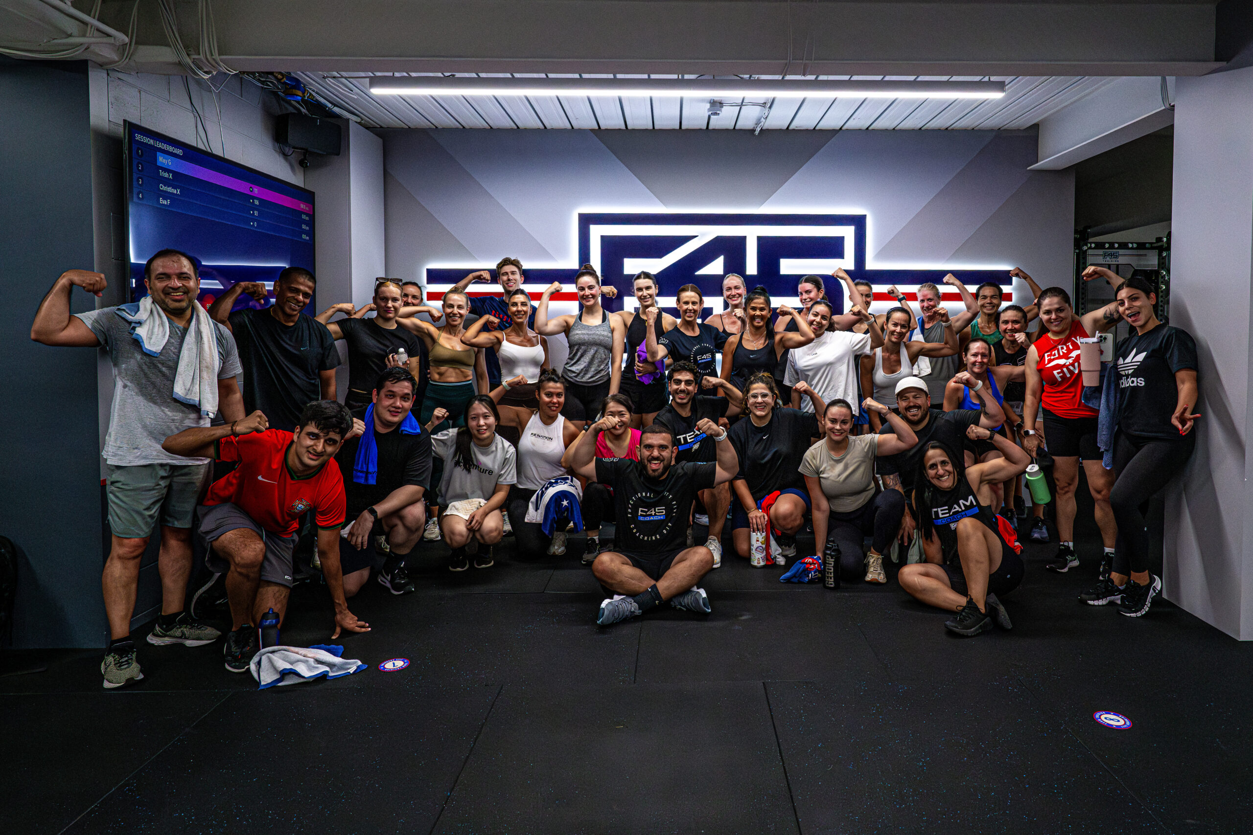 F45 Downtown Los Angeles gym with members doing HIIT and strength training exercises in a high-energy group workout session.