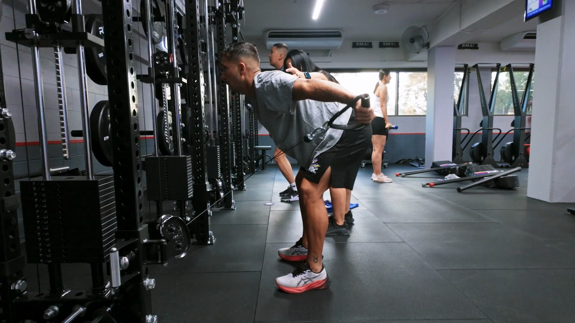 F45 class in action, combining cardio intervals and strength exercises using dumbbells and rowers